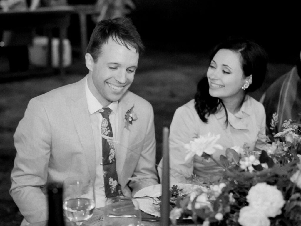 Bride and groom at outdoor wedding reception at Greenwood Community Center, in Elk, California, photographed by destination wedding photographer, Bethany Erin Photography.