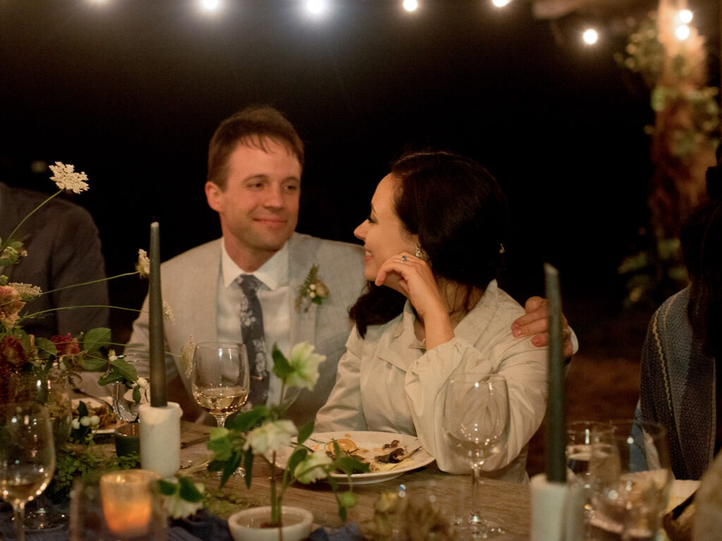 Bride and groom at outdoor wedding reception at Greenwood Community Center, in Elk, California, photographed by destination wedding photographer, Bethany Erin Photography.