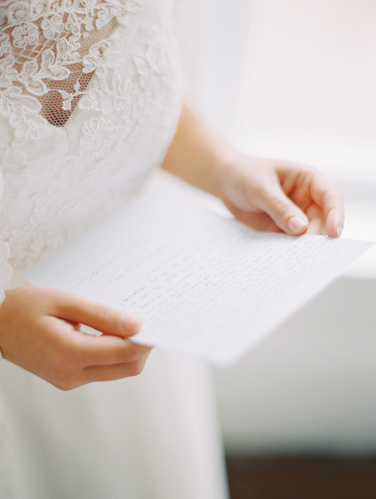 Bride reading a letter from groom in Cuffey's Cove Ranch House, photographed at wedding in Elk, California, by destination wedding photographer, Bethany Erin Photography.