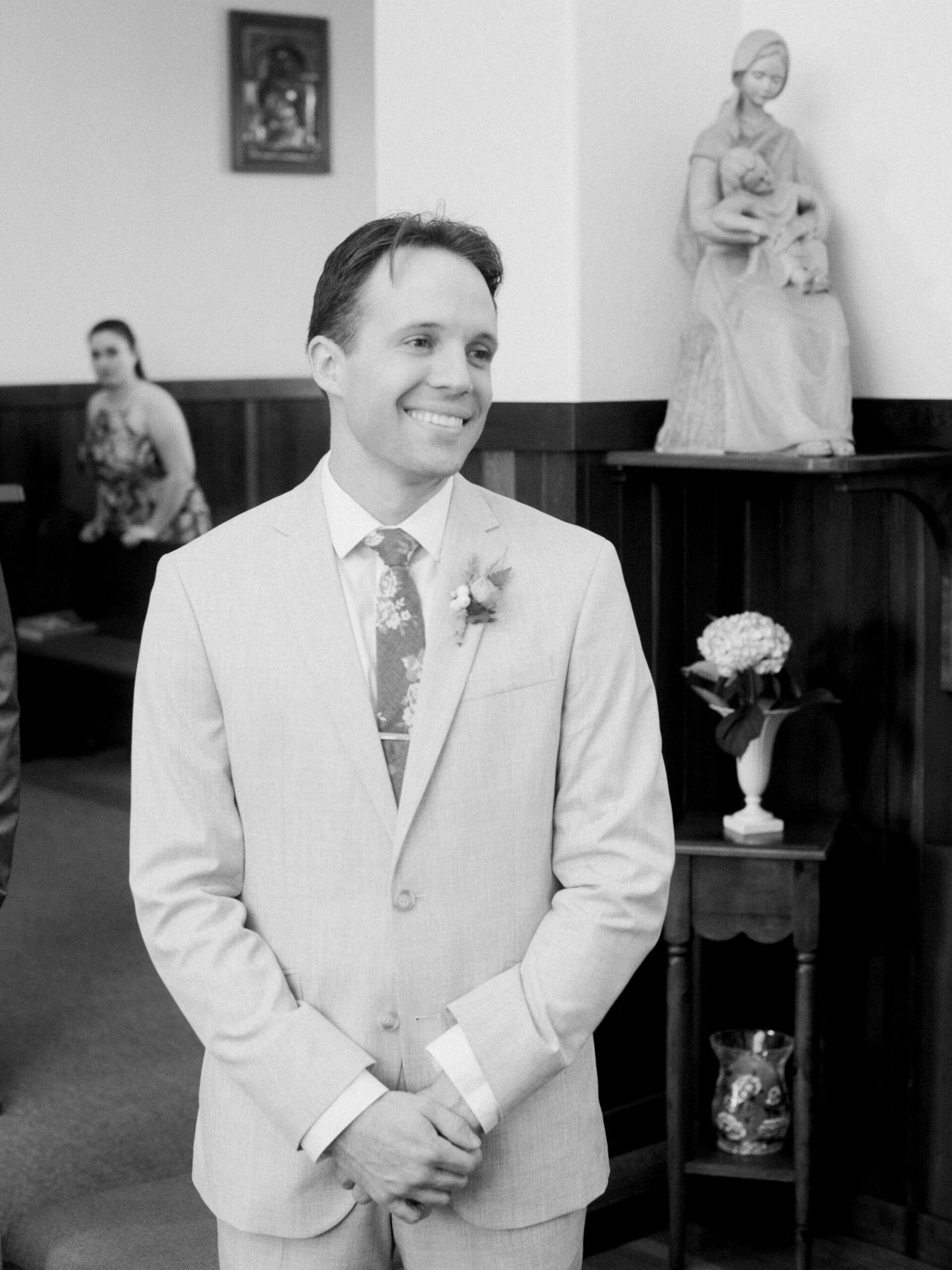 Groom during wedding in Saint Anthony's Catholic Church in Mendocino, California, by destination wedding photographer, Bethany Erin Photography.