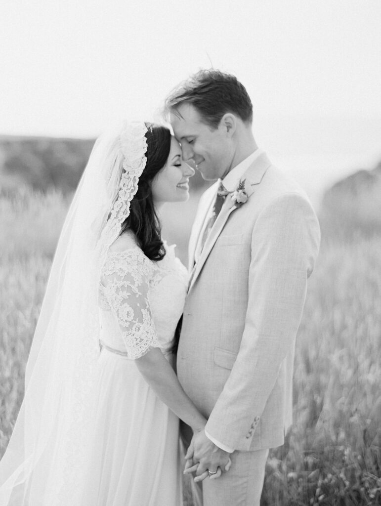 Bride & groom on cliffs, photographed at wedding in Elk, California, by destination wedding photographer, Bethany Erin Photography.