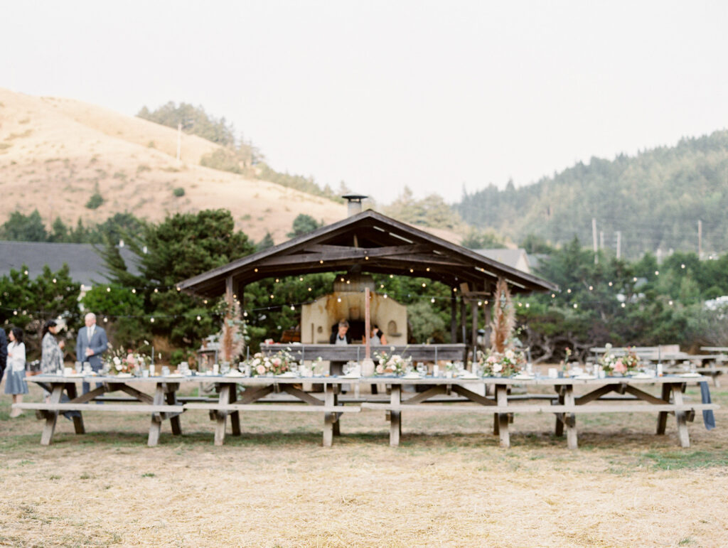 Outdoor wedding reception decor at Greenwood Community Center, in Elk, California, photographed by destination wedding photographer, Bethany Erin Photography.