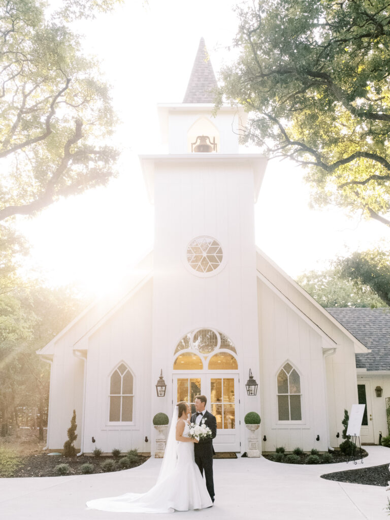 Bride and groom in front of chapel at The French Farmhouse venue, photographed by Dallas Wedding Photographer, Bethany Erin Photography. 