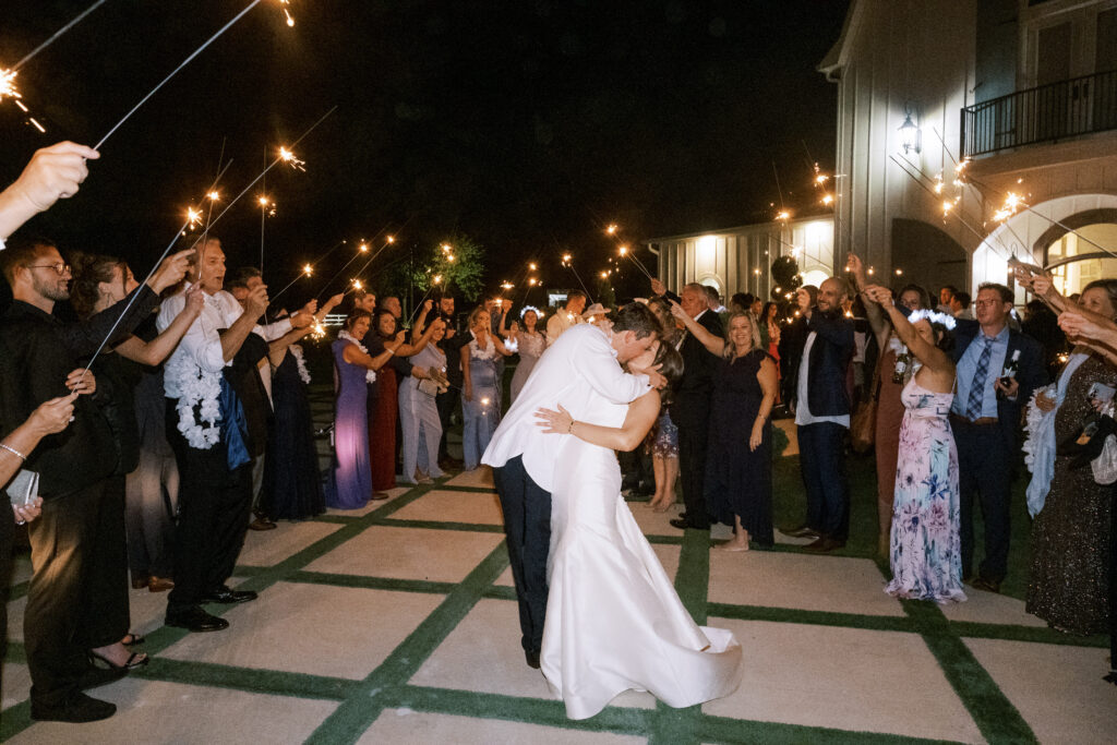 Bride and groom kiss during sparkler exit, photographed by Dallas Wedding Photographer, Bethany Erin Photography. 