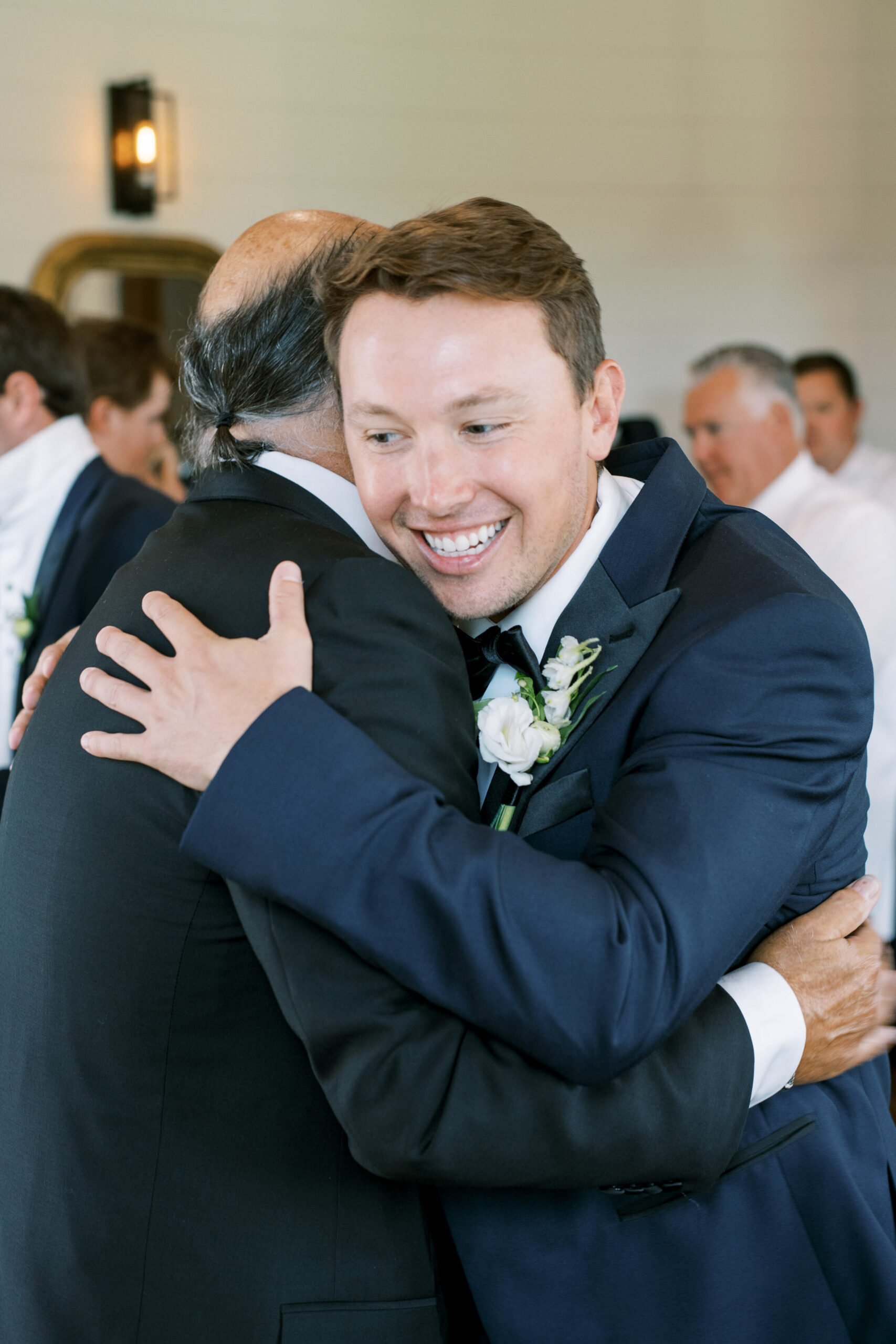 Groom and father of the bride hugging, photographed by Dallas Wedding Photographer, Bethany Erin Photography. 