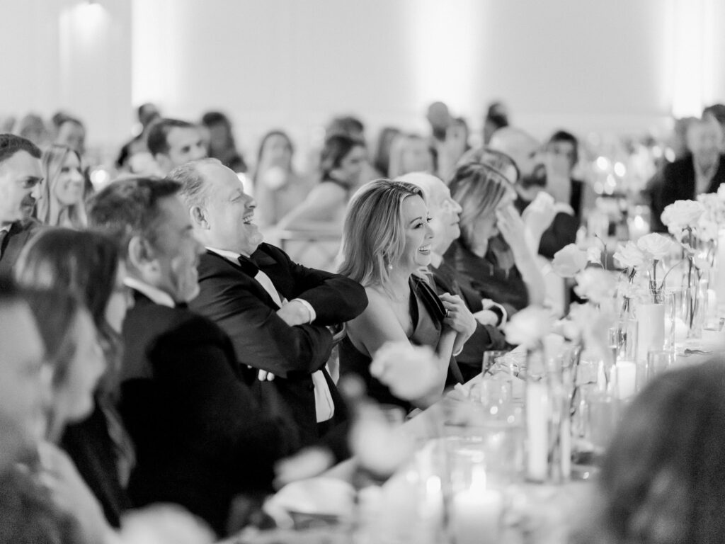 Guests watching with anticipation during bride & groom surprise baby gender reveal wedding cake cutting at Hotel Swexan, photographed by Dallas Wedding Photographer, Bethany Erin Photography.
