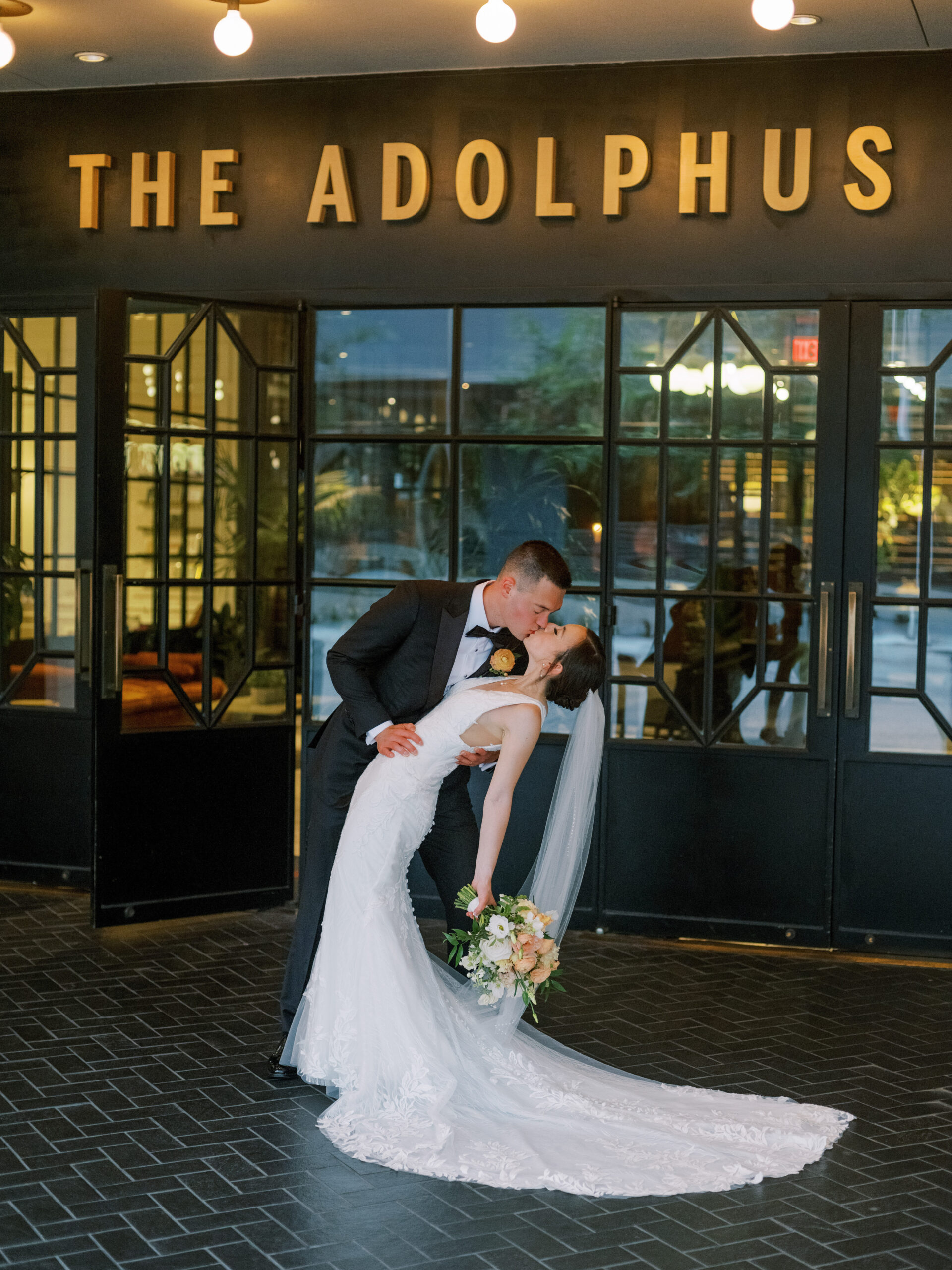Bride & groom kissing in front of The Adolphus Hotel, photographed by Dallas Wedding Photographer, Bethany Erin Photography.