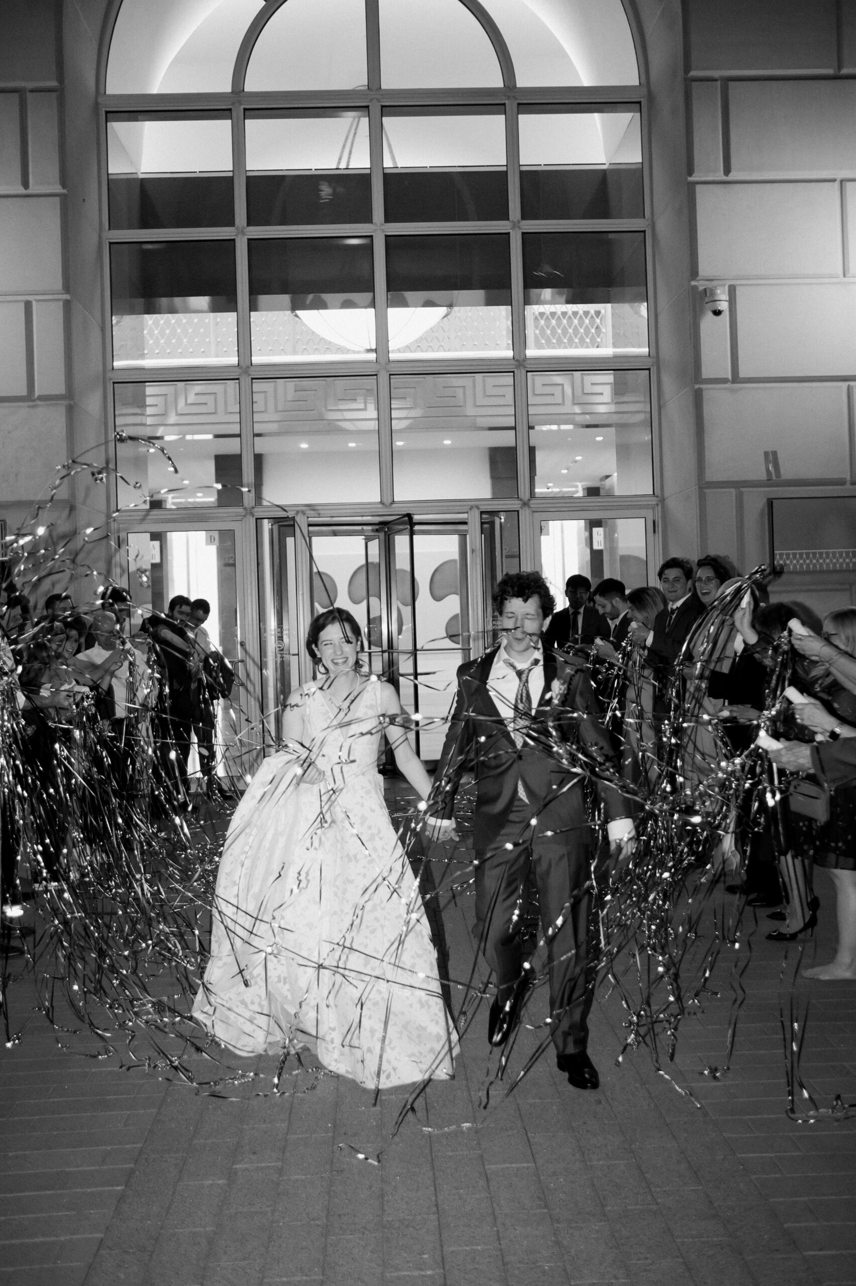Bride & groom exit their wedding reception at The Crescent Club, photographed by Dallas Wedding Photographer, Bethany Erin Photography.